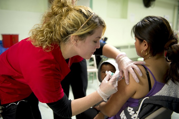 A Rutgers School of Nursing–Camden student delivers the flu vaccine at a Camden, N.J. community clinic.