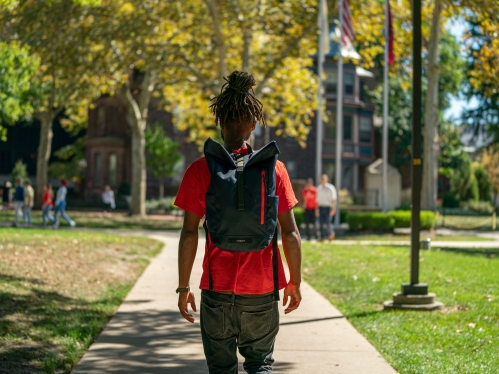 student walking in quad