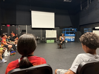 Nyeema Watson reads to the children.