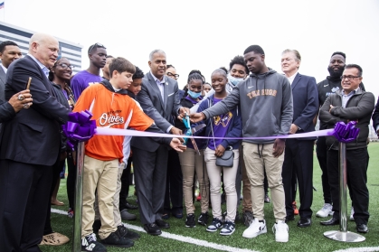 City of Camden Mayor Victor Carstarphen cuts the ceremonial ribbon with the help of Camden youth players, officially opening the Camden Athletic Complex.
